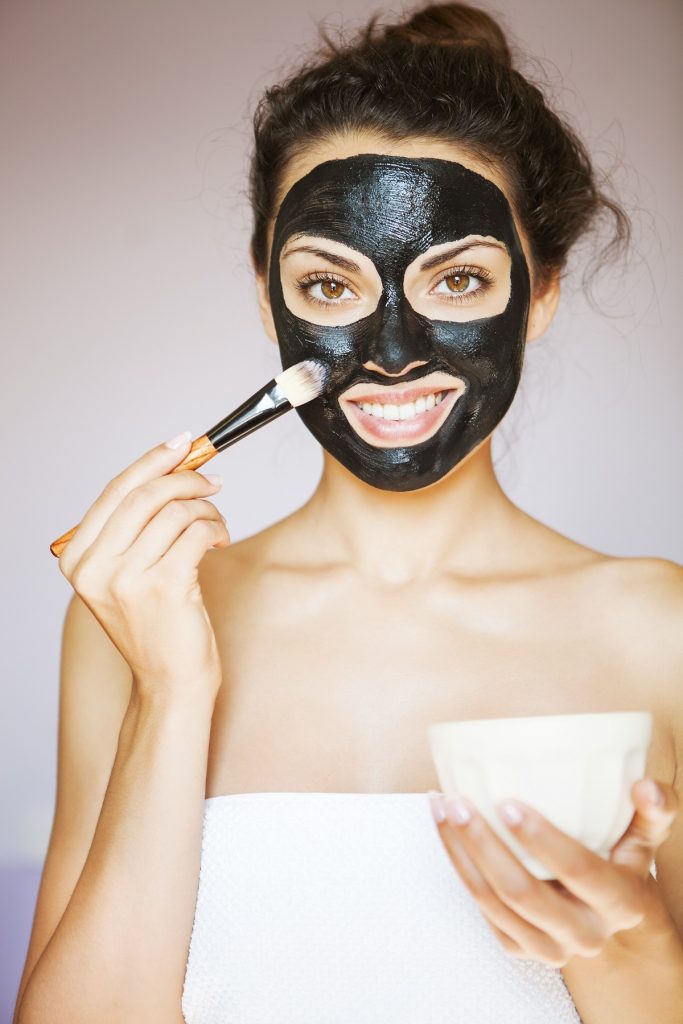 woman applying black mud