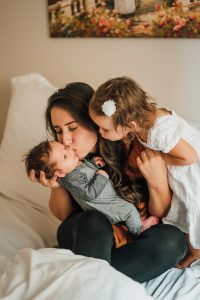 mother kissing a baby